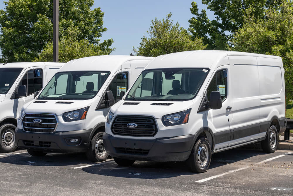 White Ford Transits parked side to side